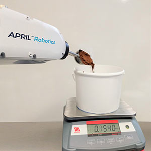 APRIL cobot weighs cocoa in the workcell