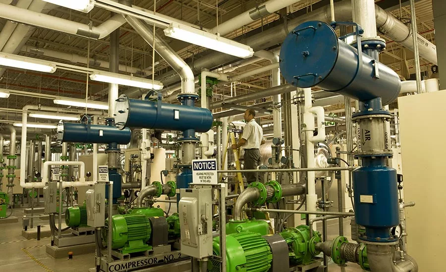 Engineer with air compressors in water treatment plant